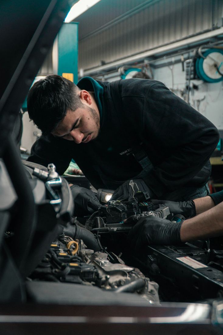 Mechanic leaning into an engine bay