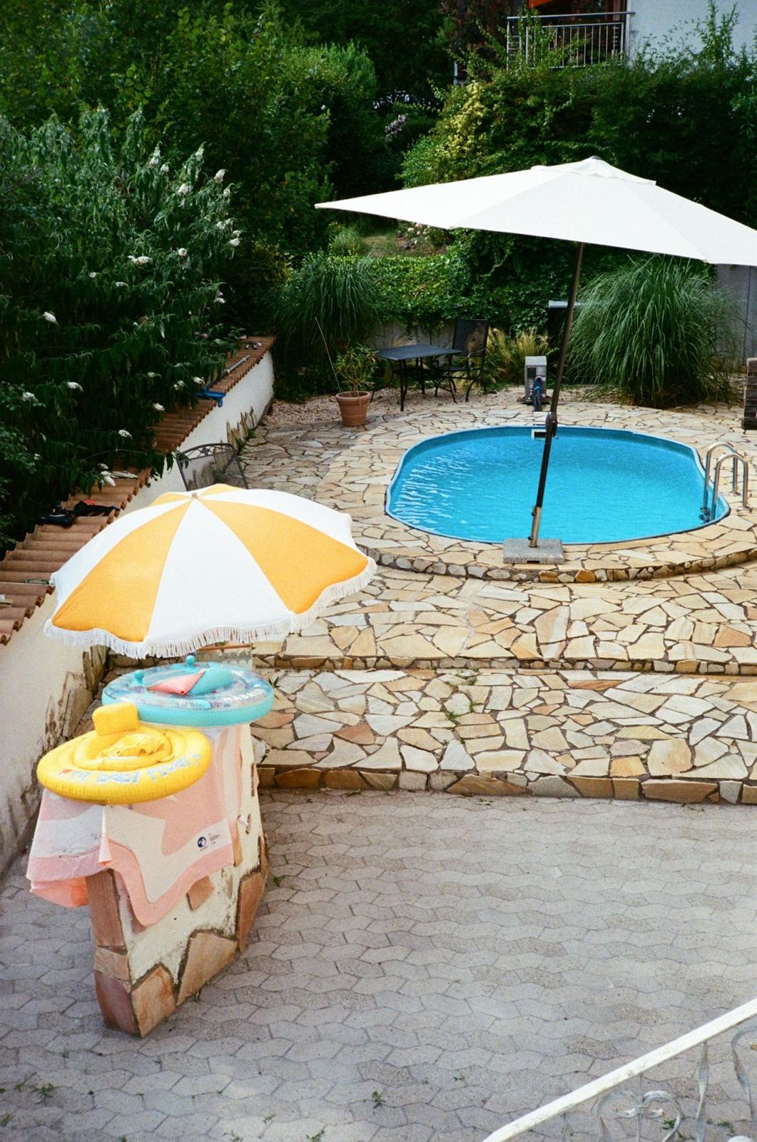 Backyard pool surrounded by a stone deck
